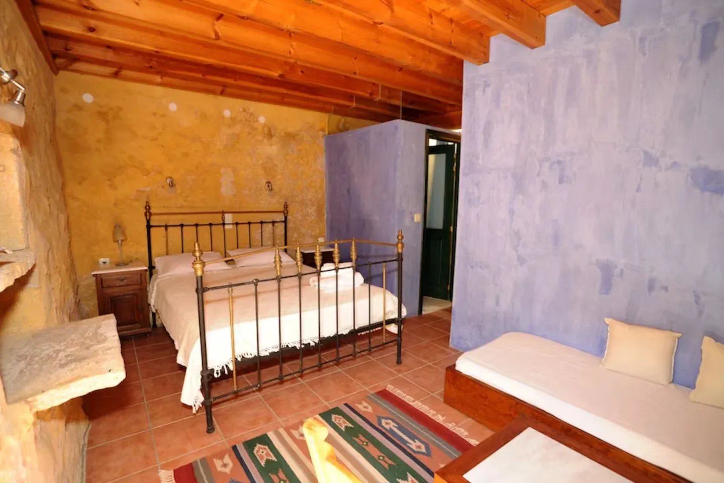 Stylish bedroom with stone walls and warm lighting