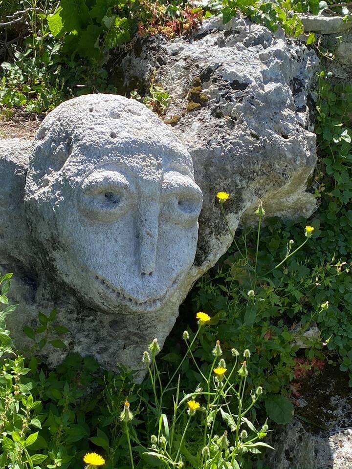 Mysterious stone face carved into rock near the Cave of St. Anthony